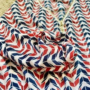 Fun dress with orange and blue pattern and gold zipper on the front!